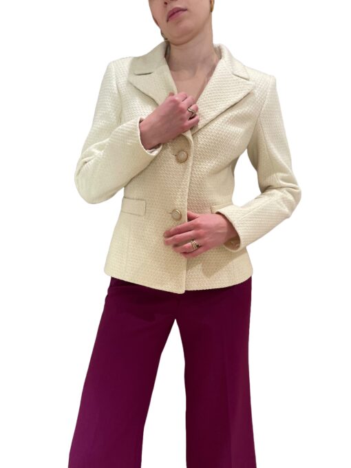 White boucle jacket with gold color buttons and magenta pants